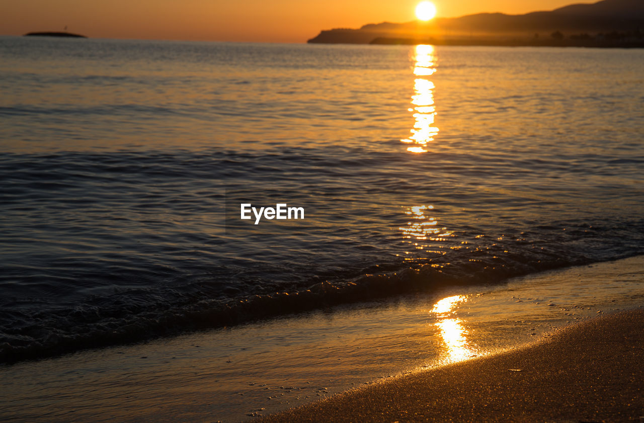 Scenic view of sea against sky at sunset