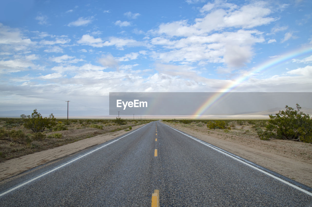 Mojave desert highway with rainbow