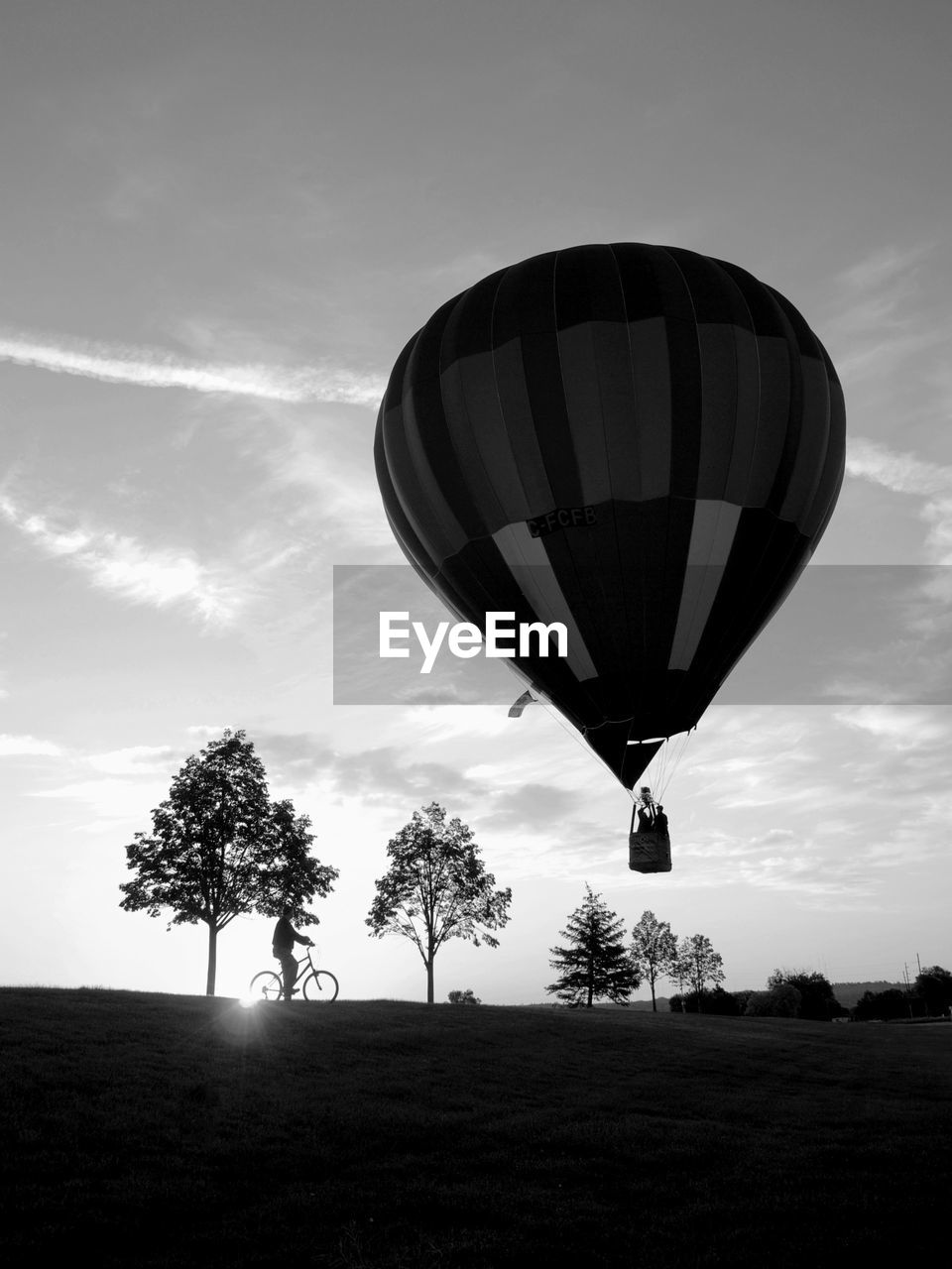 LOW ANGLE VIEW OF HOT AIR BALLOON ON FIELD