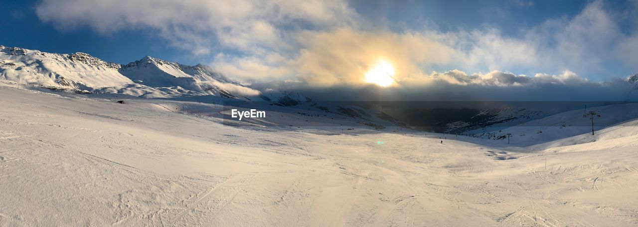 Scenic view of snowcapped mountains against sky during winter