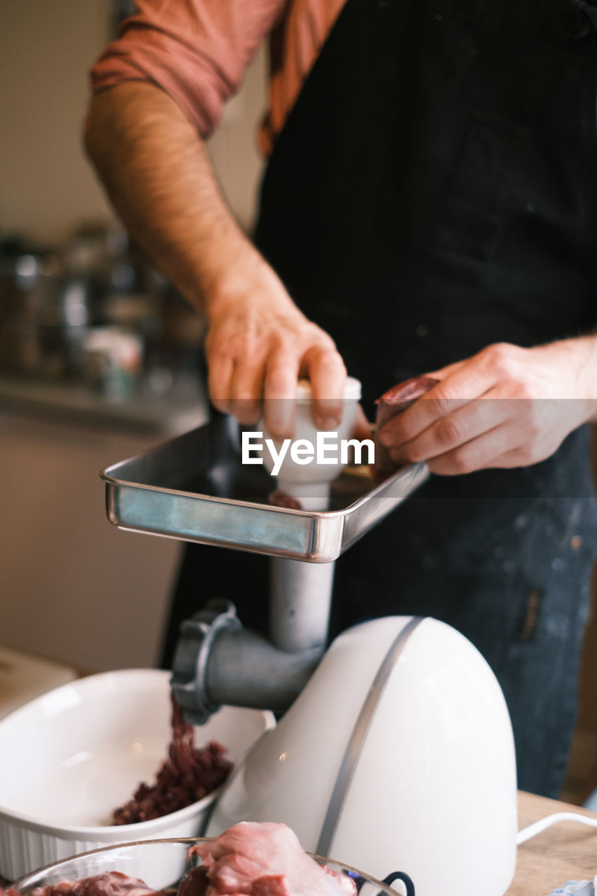 Midsection of man preparing food