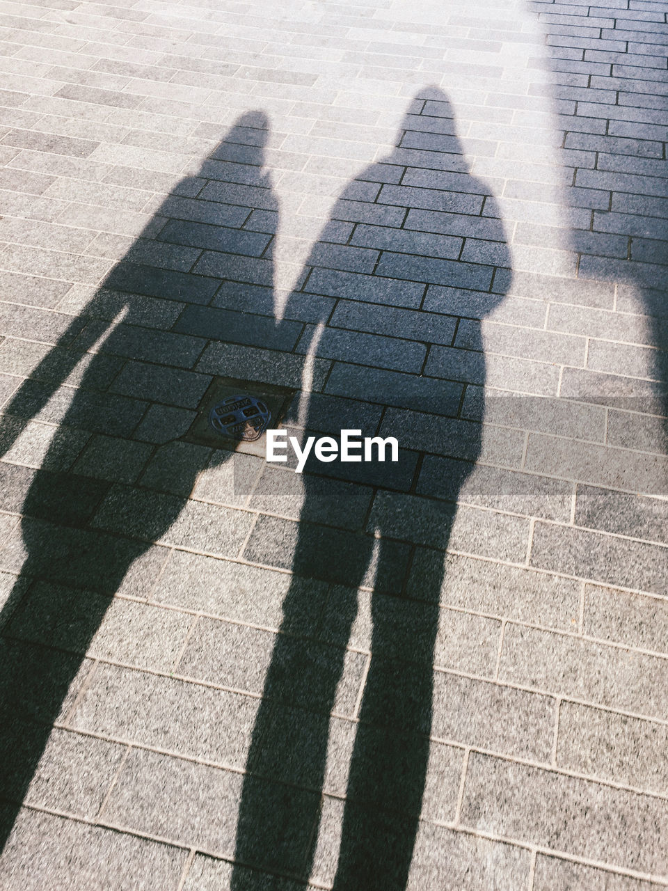 Shadow of people on street