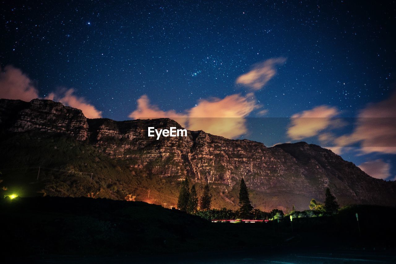 MOUNTAINS AGAINST SKY AT NIGHT