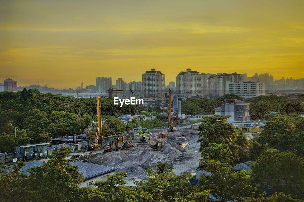 High angle view of buildings in city during sunset