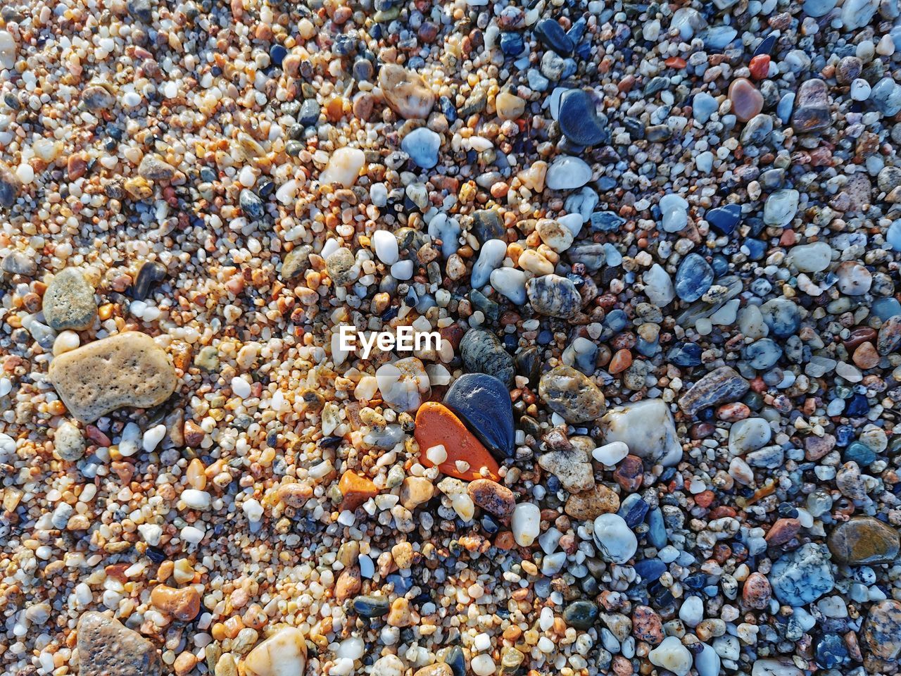 High angle view of pebbles on beach