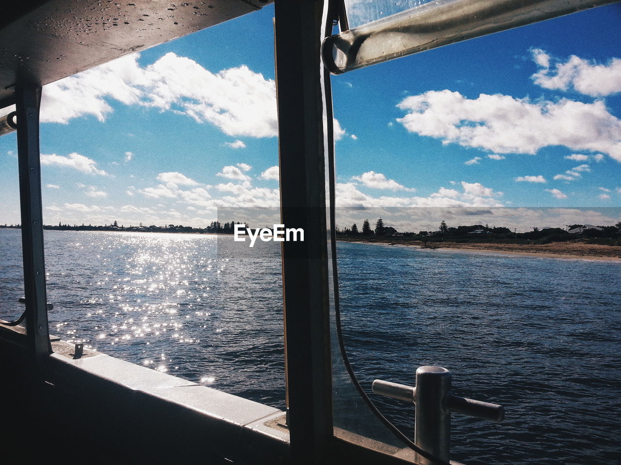 Scenic view of sea against sky seen through window