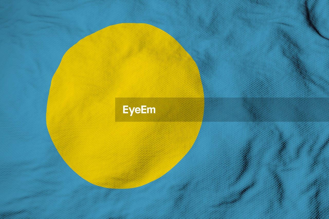 Full frame close-up on a waving flag of palau in 3d rendering.