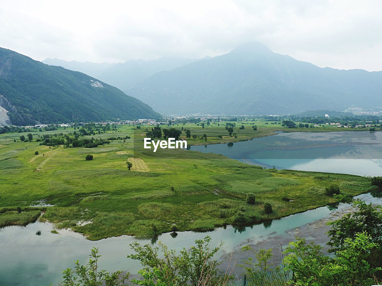 Scenic view of field and mountains against sky