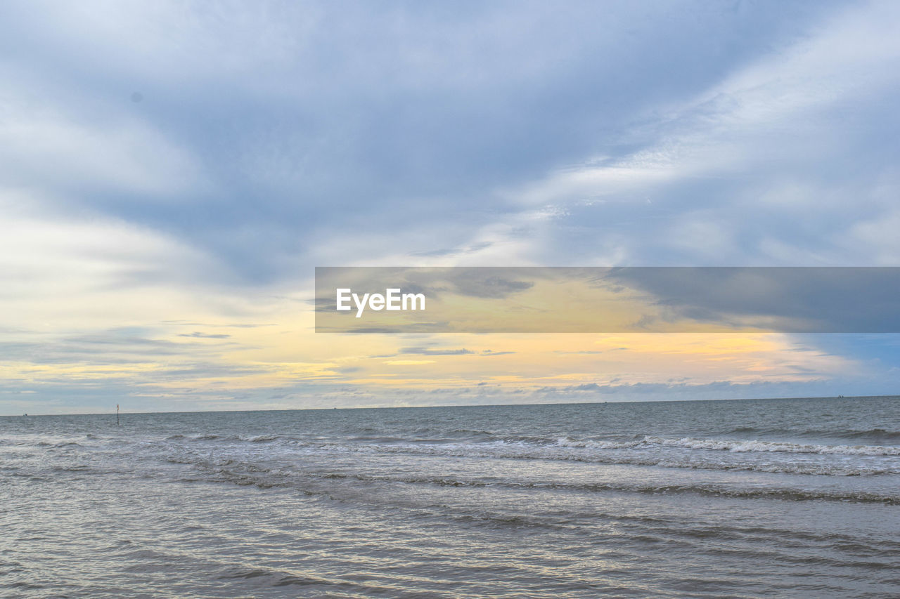 sky, sea, cloud, water, beauty in nature, scenics - nature, horizon over water, horizon, shore, ocean, nature, tranquility, body of water, land, wind wave, beach, sunset, tranquil scene, coast, seascape, wave, dramatic sky, environment, no people, idyllic, outdoors, motion, cloudscape, travel, blue, travel destinations, sunlight, landscape, day, urban skyline