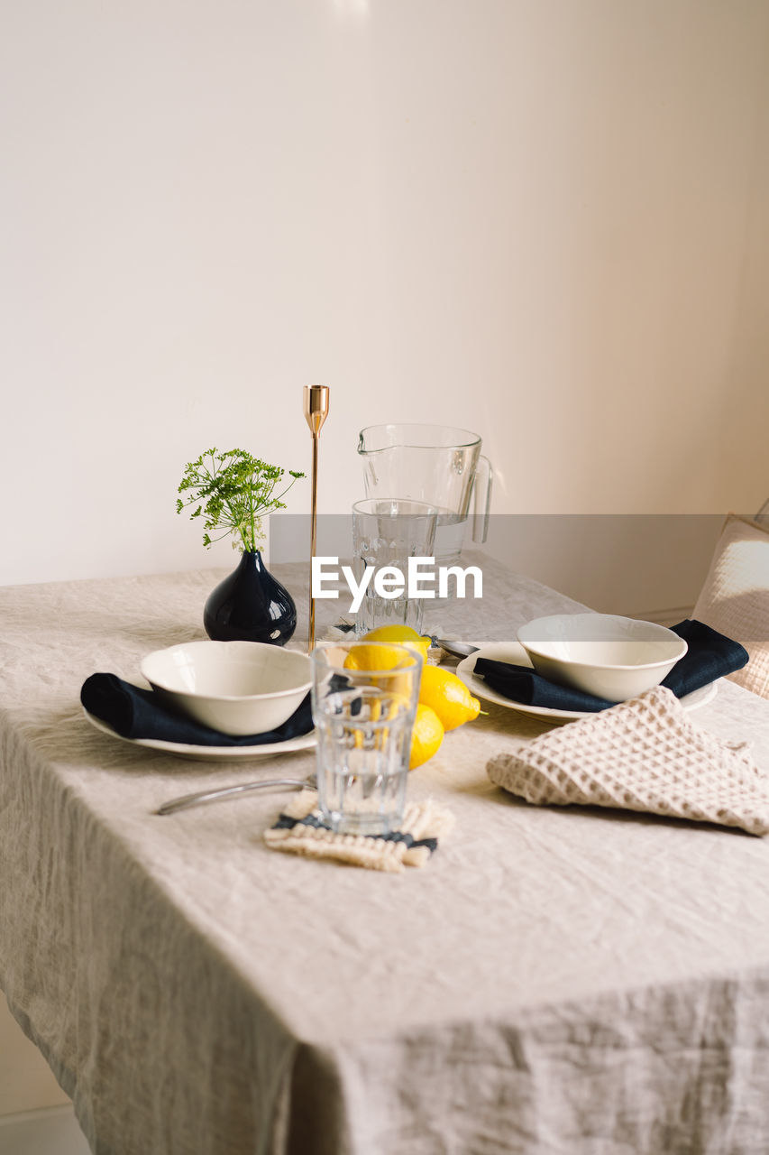 Vintage table setting with linen napkins and yellow lemons.