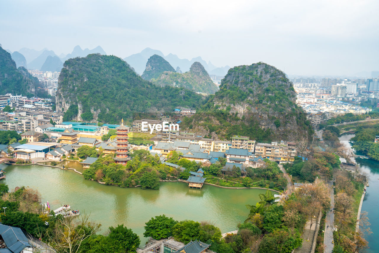 High angle view of river by townscape against sky