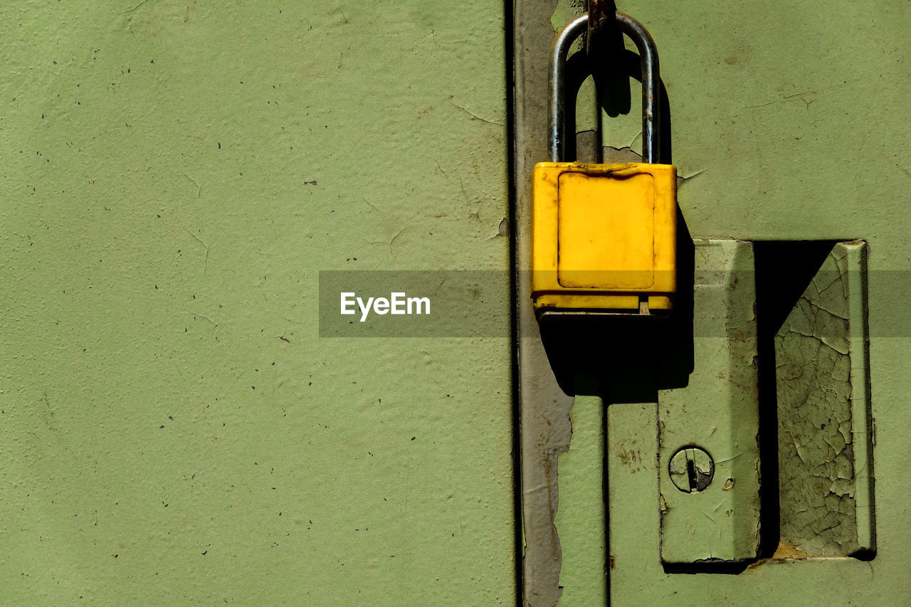 CLOSE-UP OF CLOSED DOOR WITH YELLOW METAL