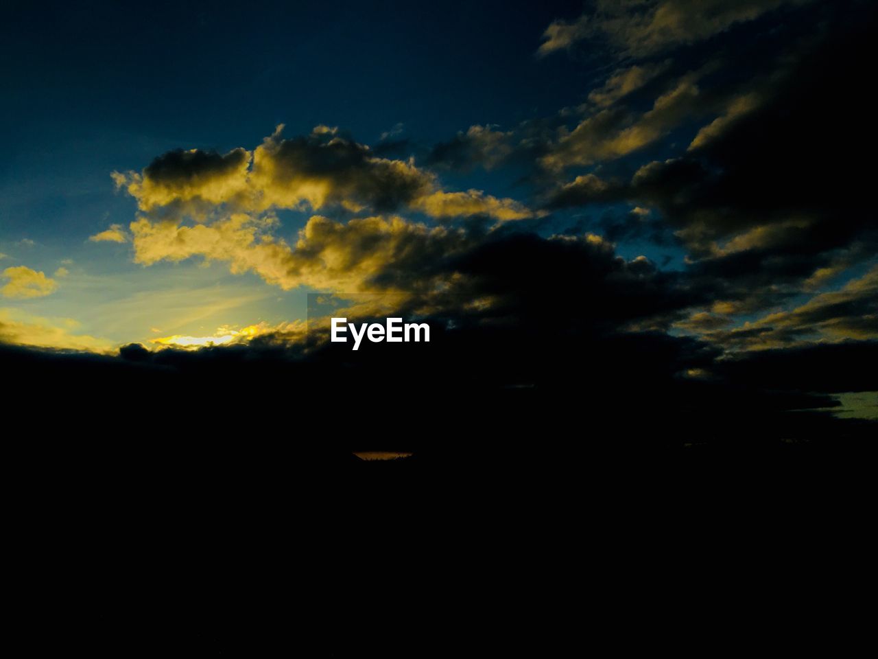 SCENIC VIEW OF SILHOUETTE LANDSCAPE AGAINST DRAMATIC SKY