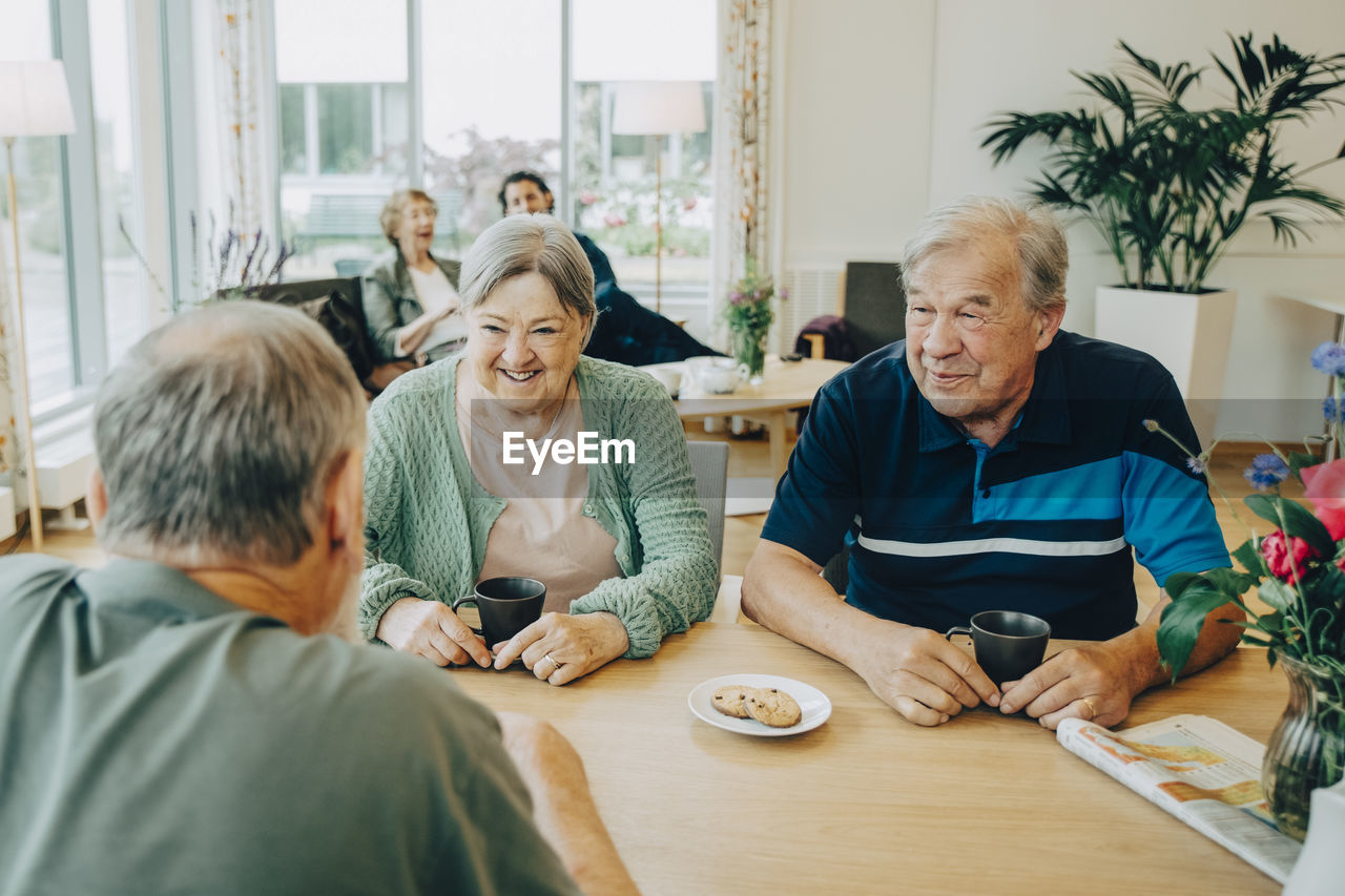 FRIENDS SITTING AT TABLE