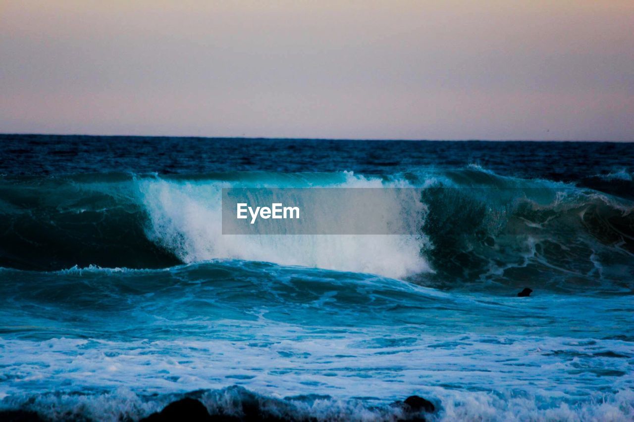 WAVES SPLASHING ON ROCKS