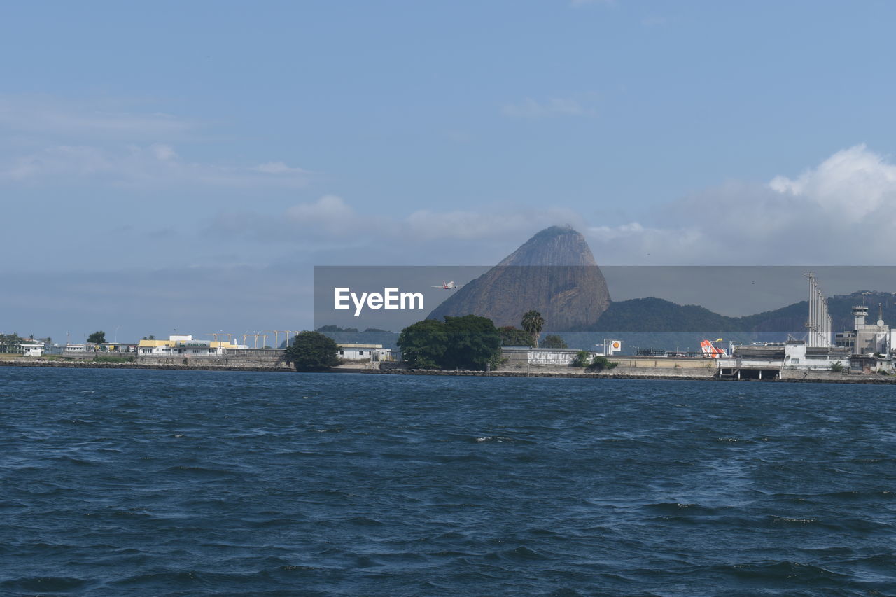 SCENIC VIEW OF SEA BY CITY AGAINST SKY