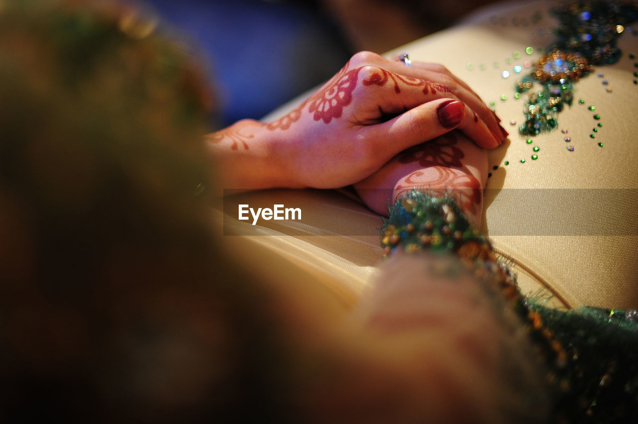 Close-up of henna tattoo on bride hands