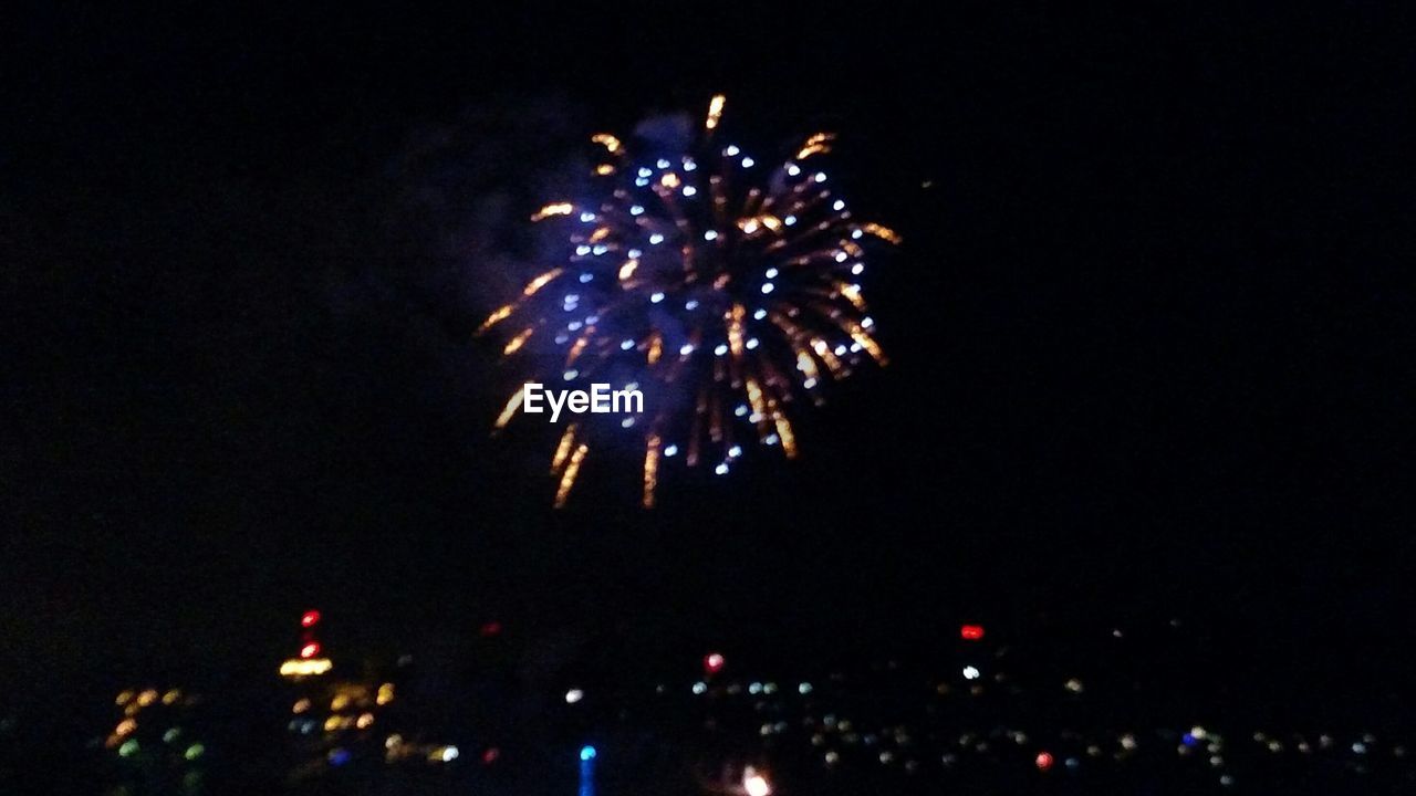LOW ANGLE VIEW OF FIREWORKS DISPLAY