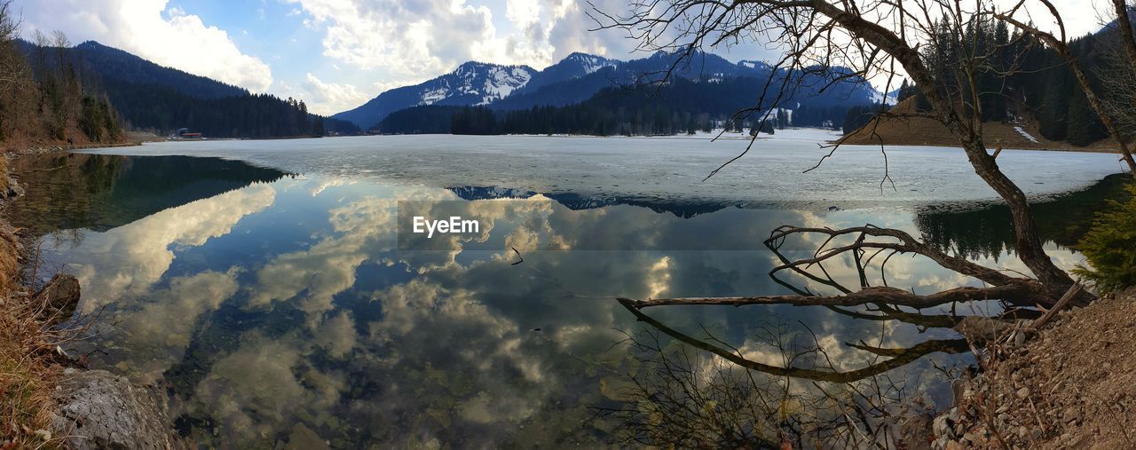 Scenic view of lake against sky during winter