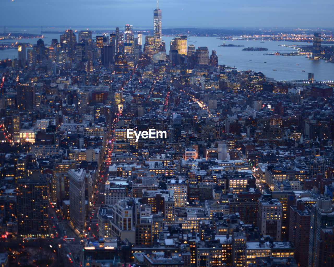 Aerial view of illuminated cityscape at dusk