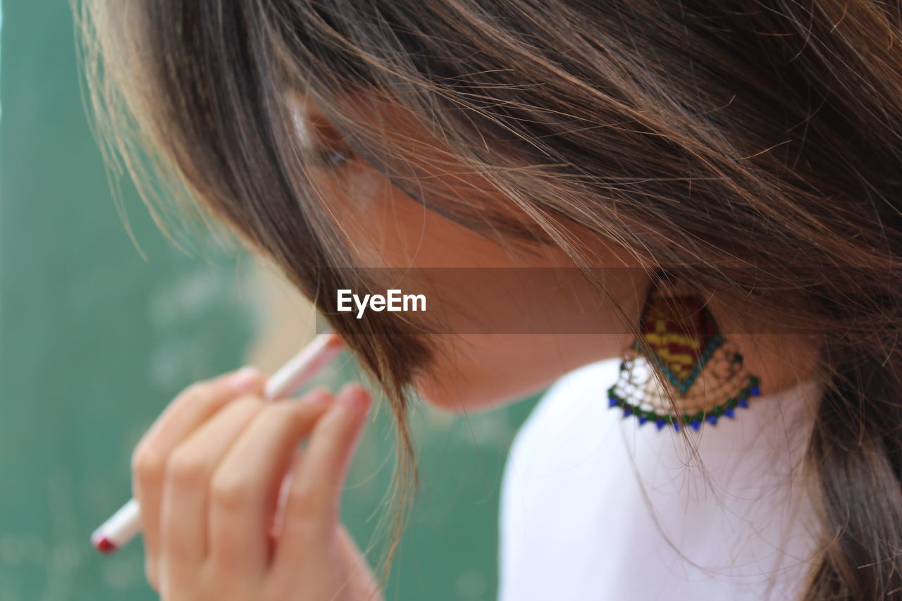 Close-up of woman applying make-up