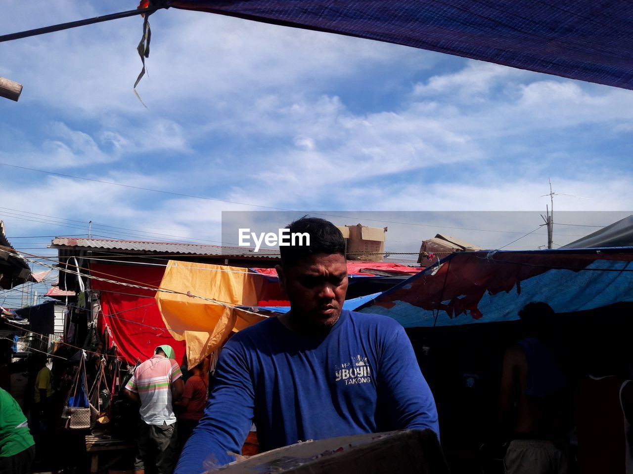 FULL LENGTH OF YOUNG MAN IN MARKET