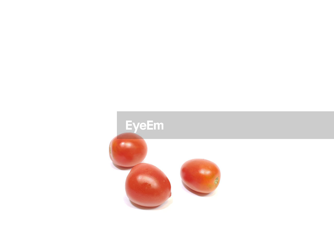 Close-up of tomatoes over white background