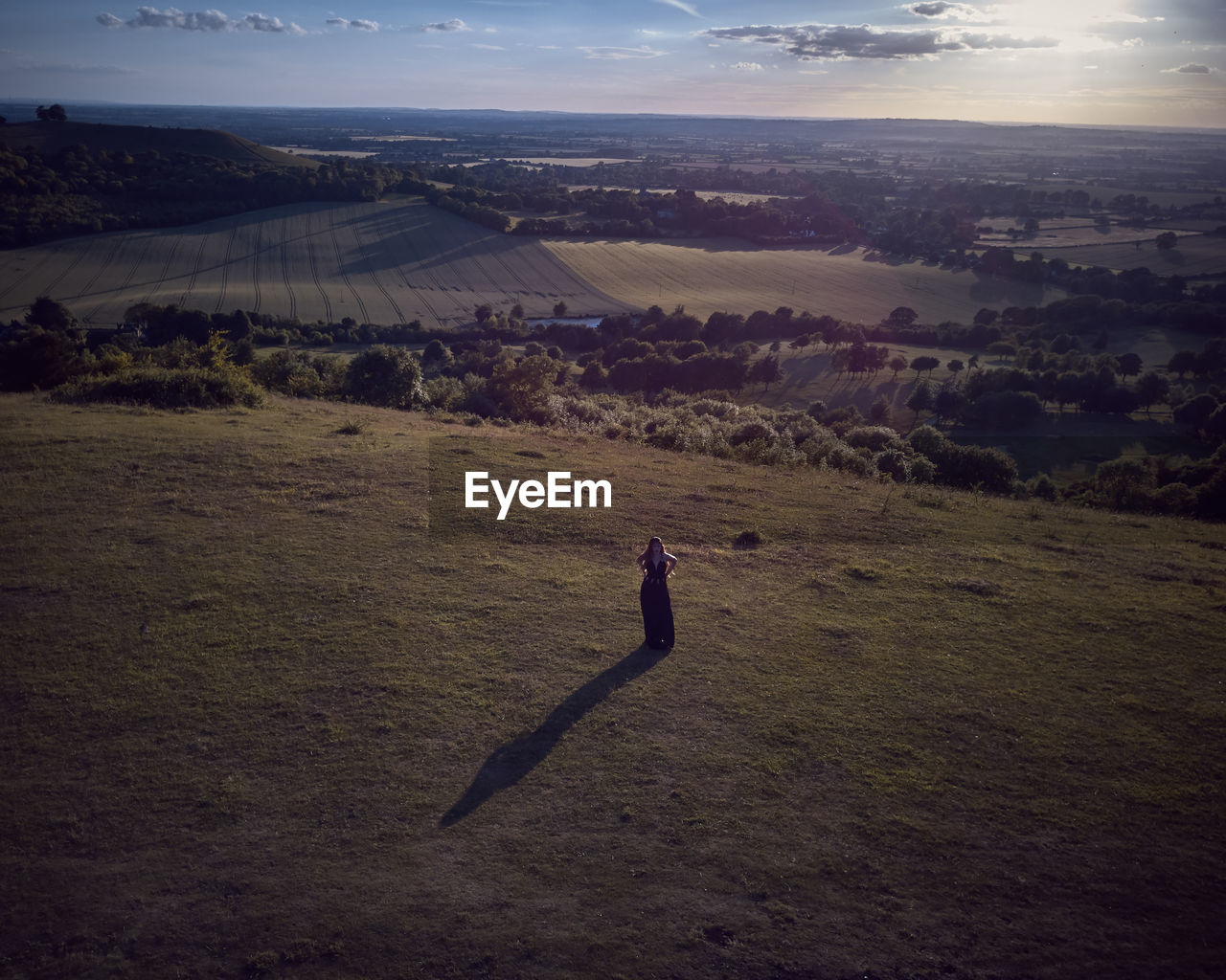 Woman on field against sky