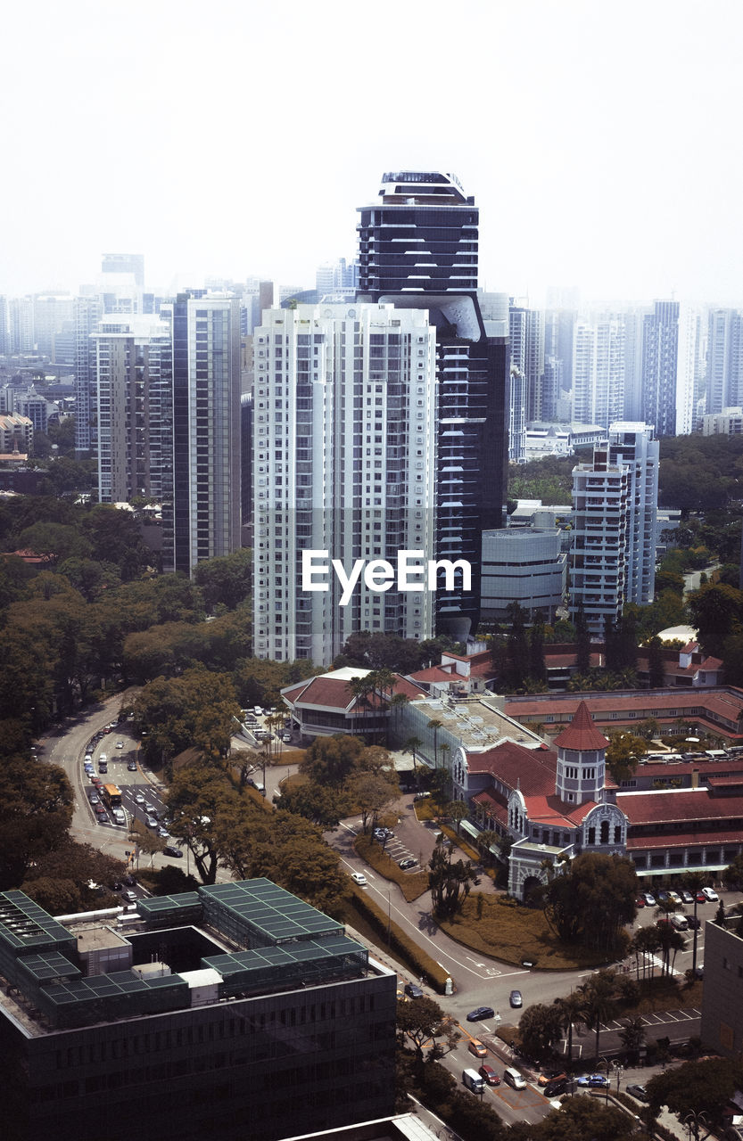 HIGH ANGLE VIEW OF MODERN BUILDINGS AGAINST SKY IN CITY