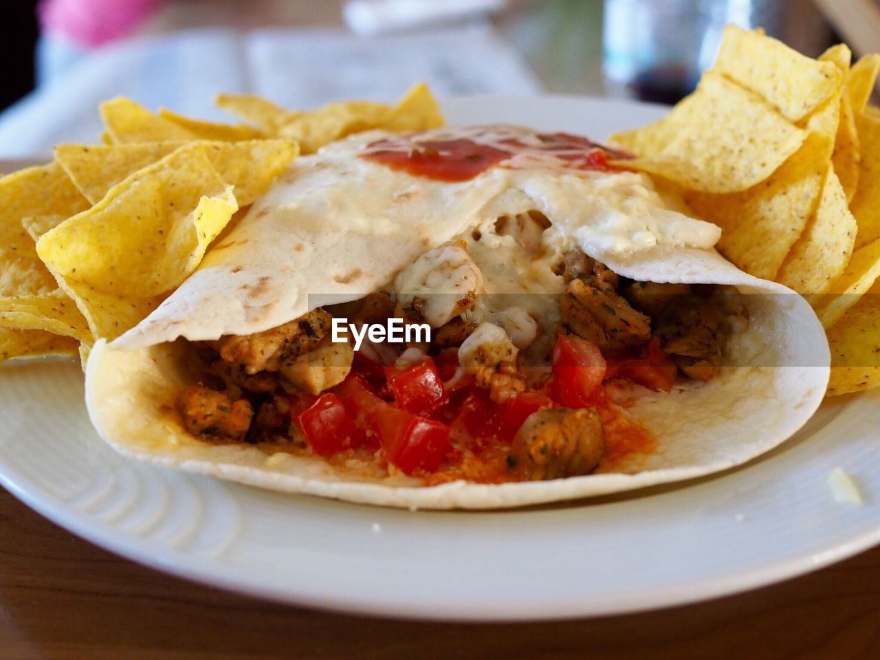 Close-up of burrito served in plate on table