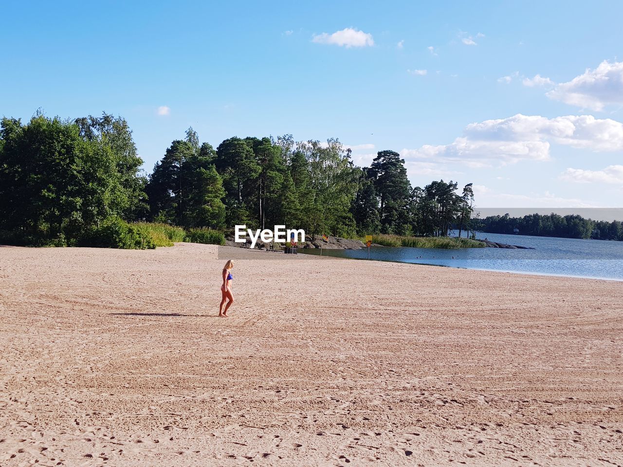 Woman on beach against sky