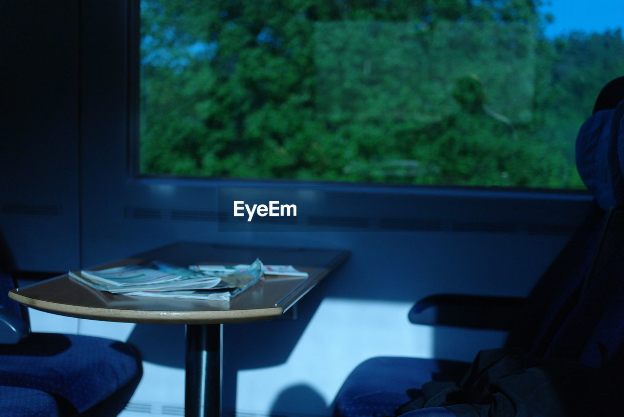 Table and seat by window in train