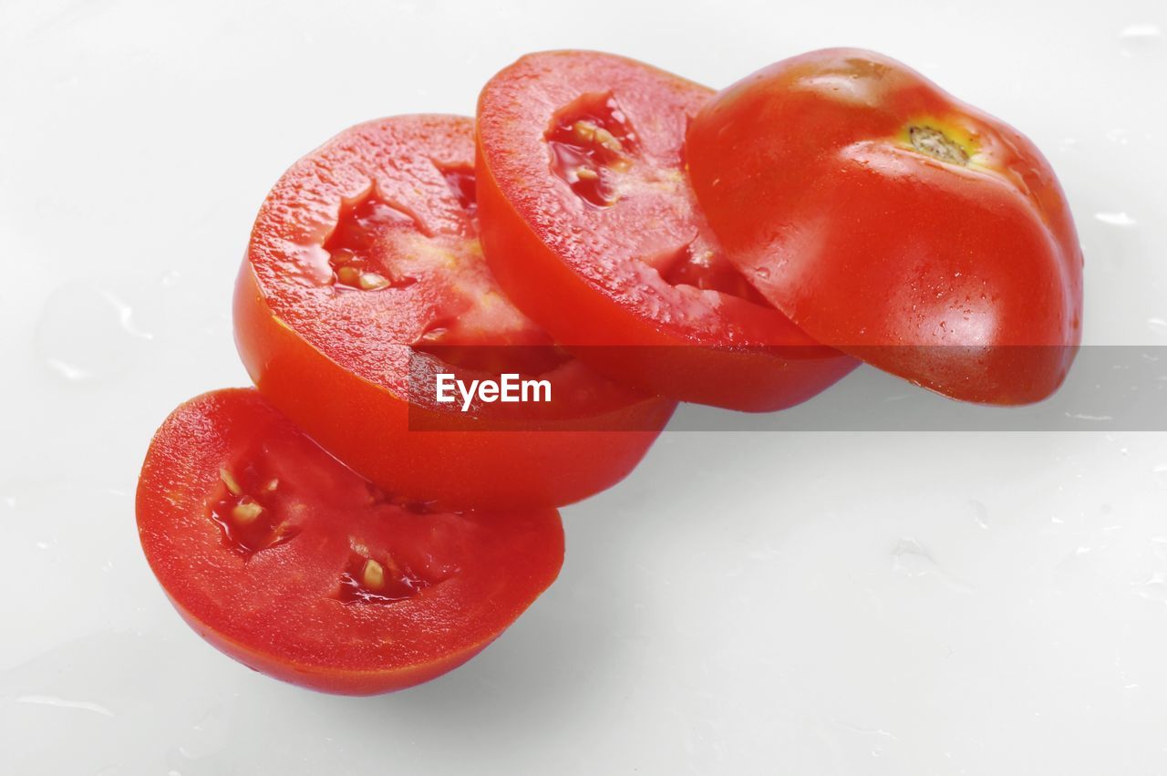 Close-up of tomato slices against white background