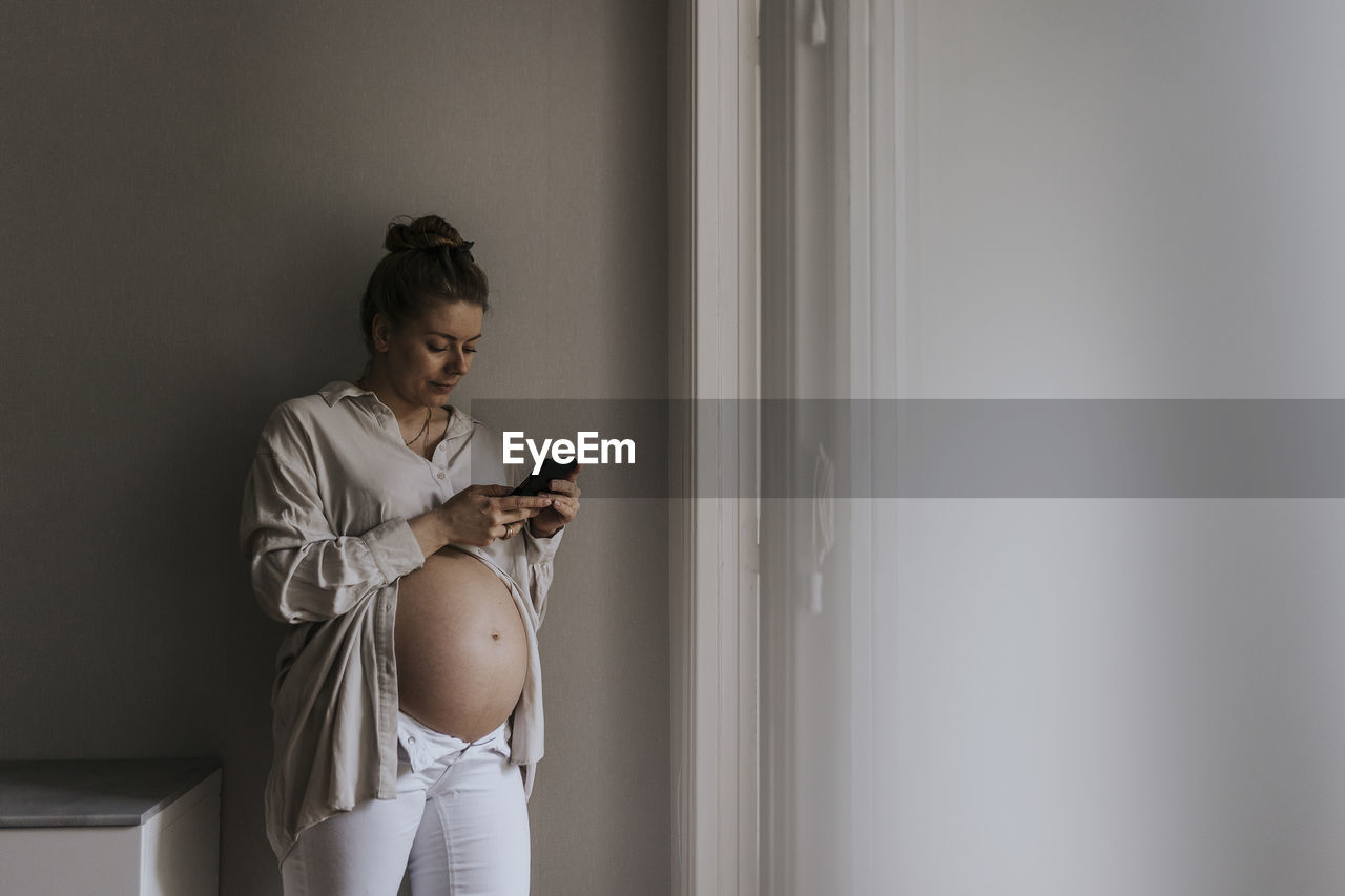 Pregnant woman using cell phone