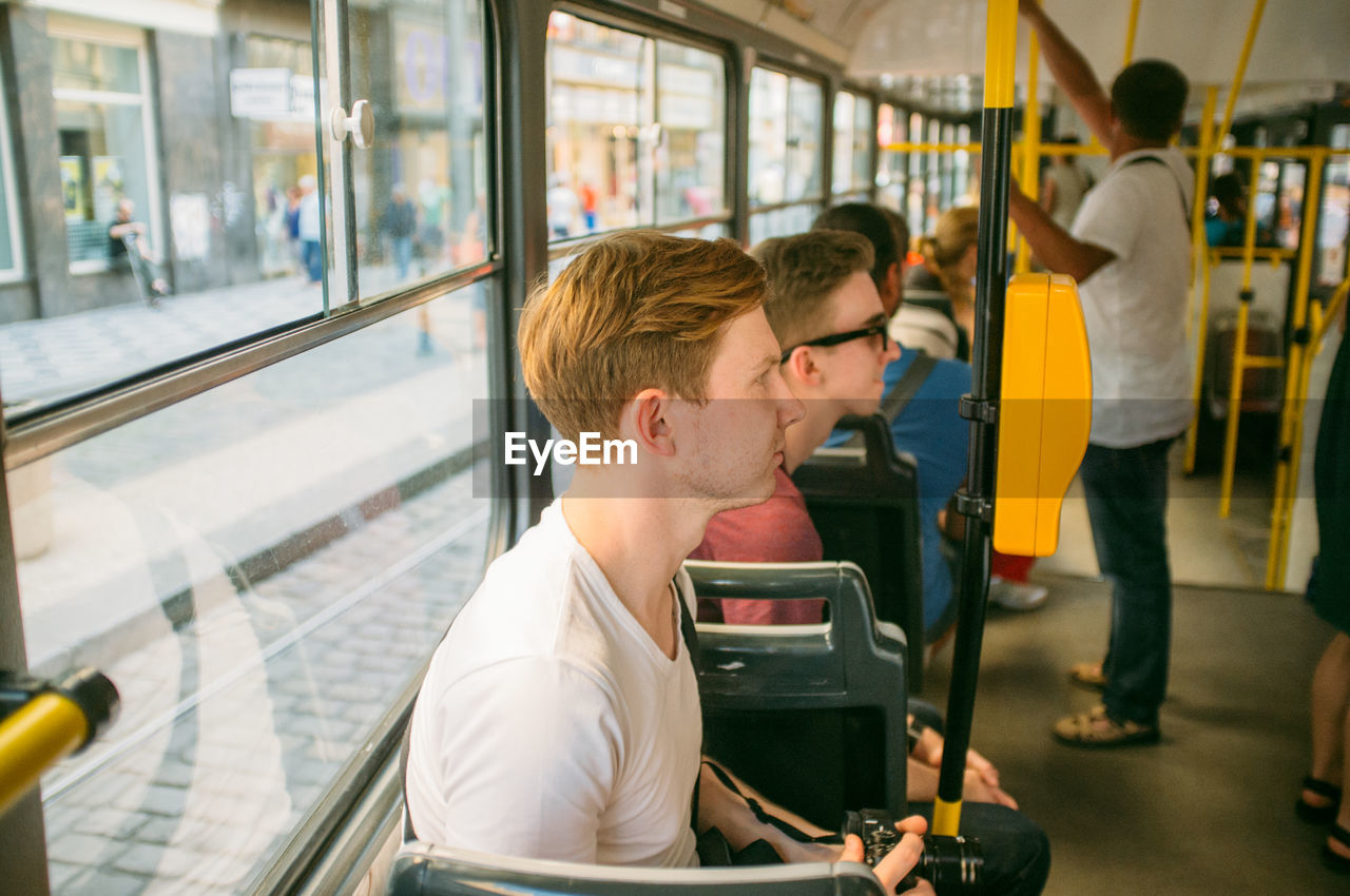 Handsome young man traveling in bus