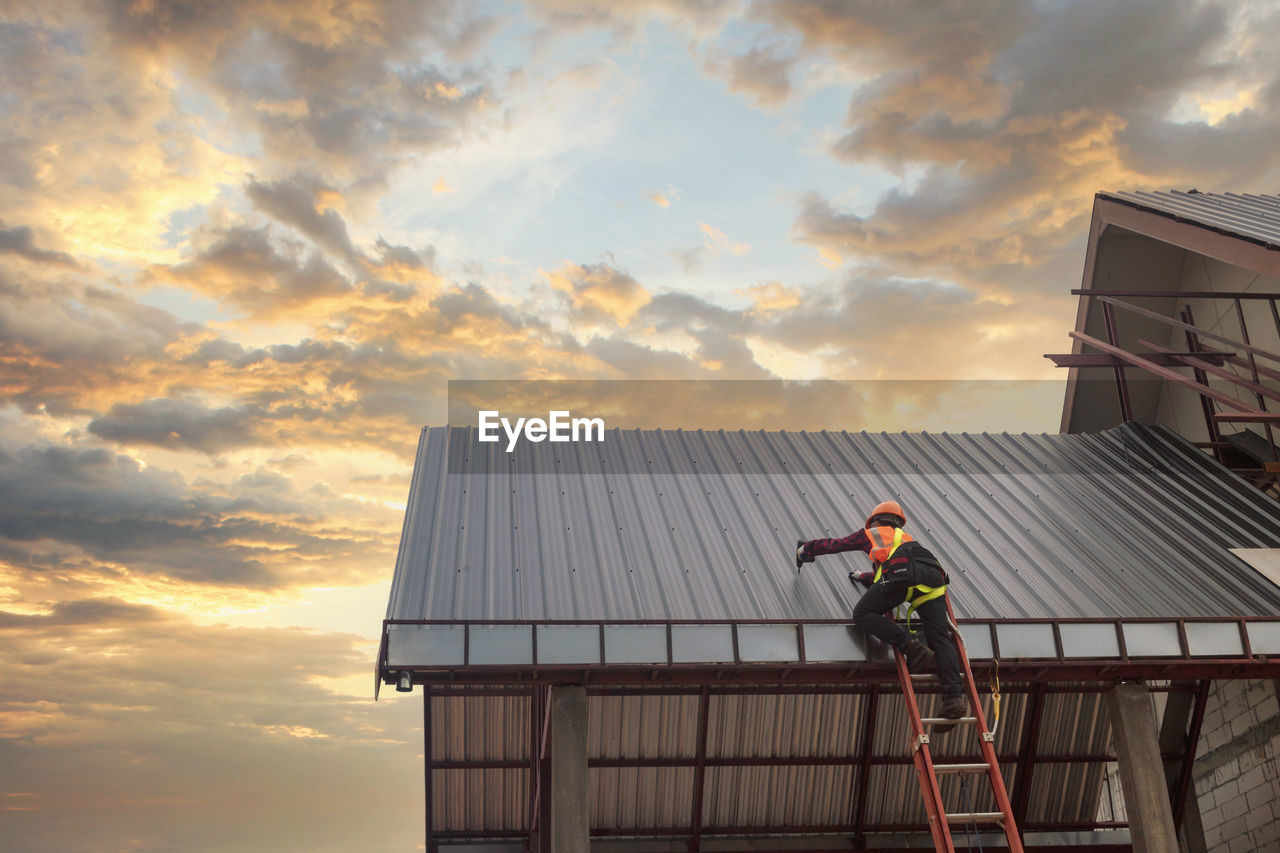 Roofer construction worker install new roof