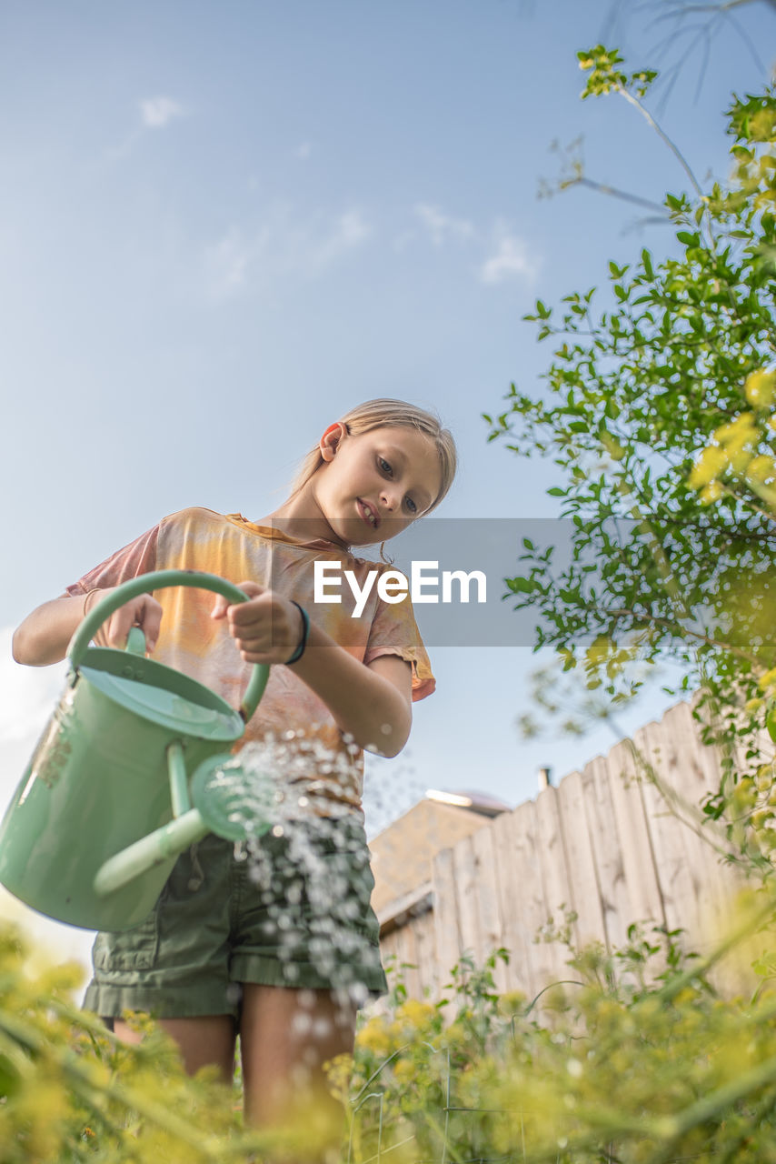 Girl watering her garden