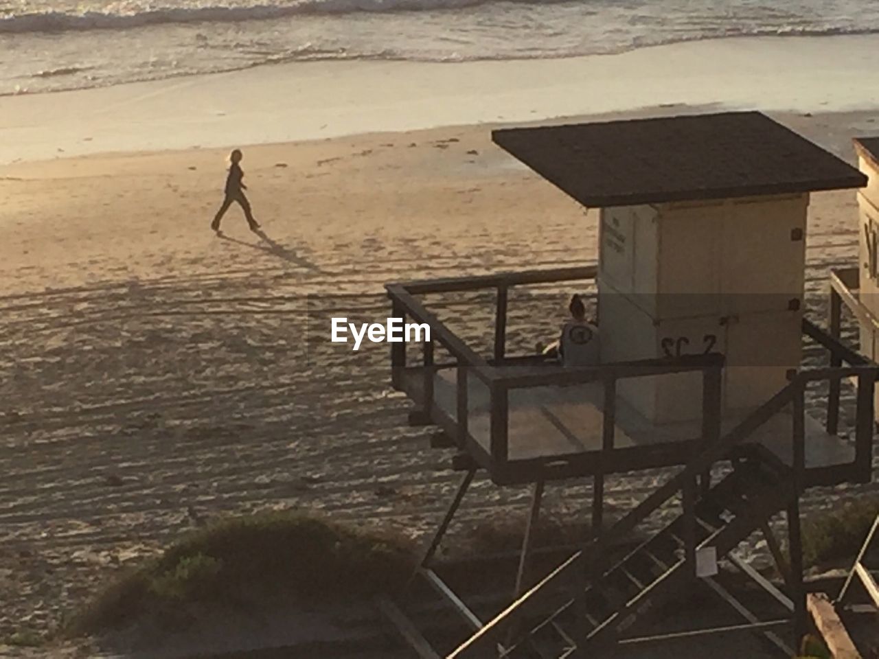 WOMAN STANDING ON BEACH