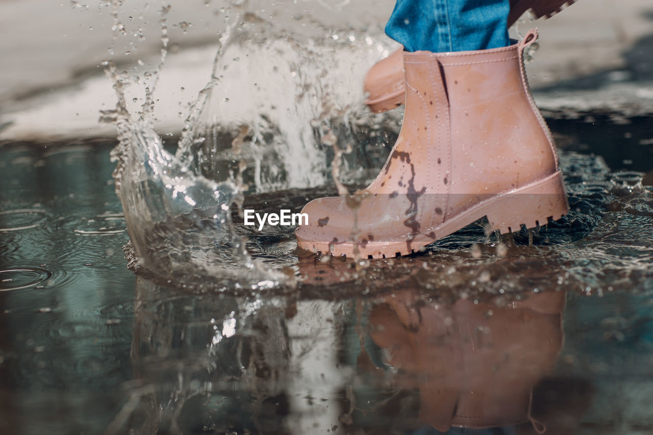 Low section of child splashing water
