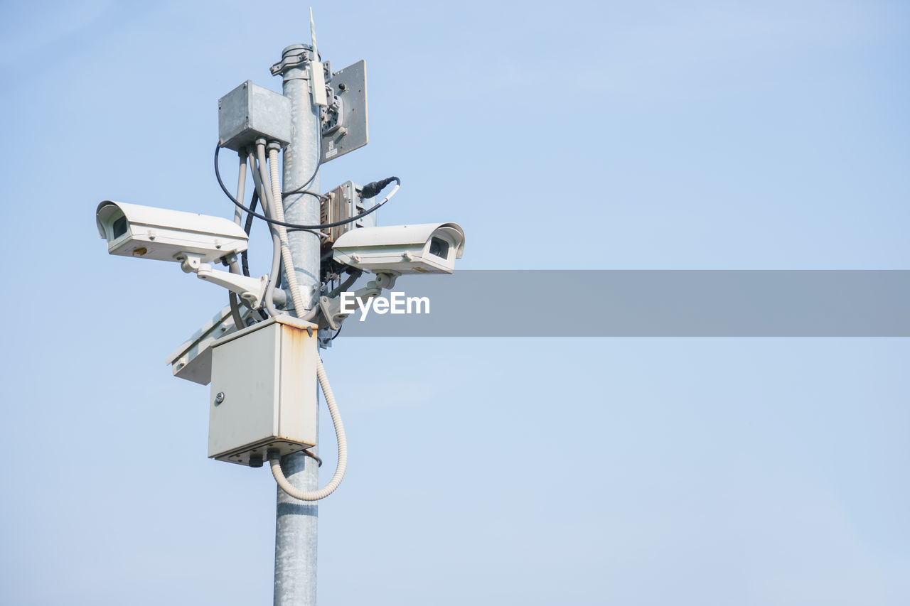 Low angle view of telephone pole against clear sky