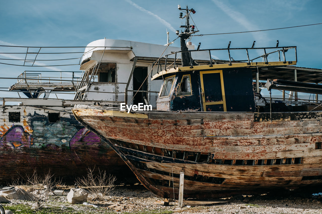 Abandoned boat against sky