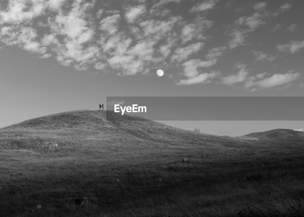 Scenic view of full moon over field against sky