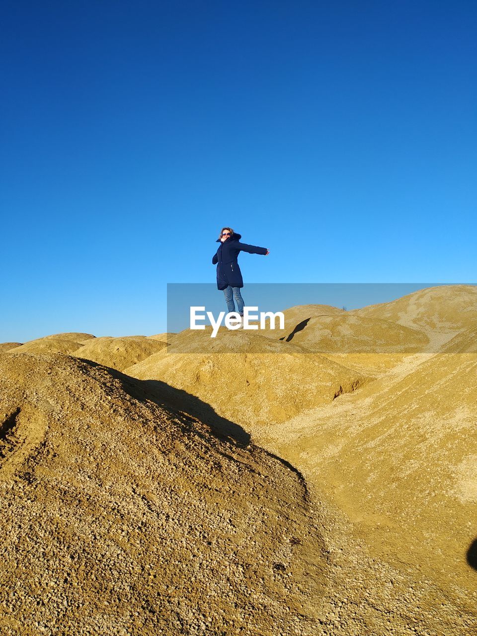 Low angle view of man standing on land against clear sky