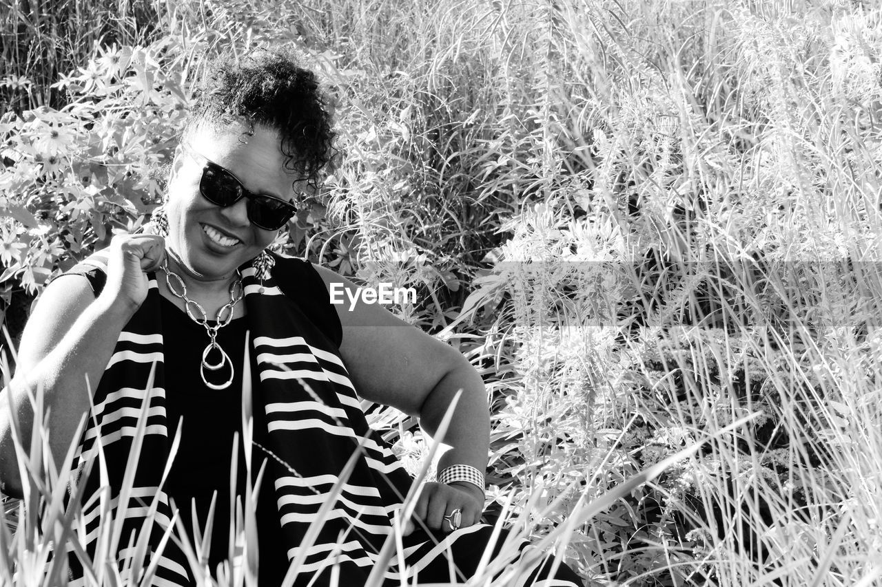 WOMAN SITTING ON FIELD