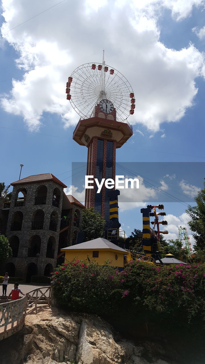 LOW ANGLE VIEW OF COMMUNICATIONS TOWER AGAINST CLOUDY SKY