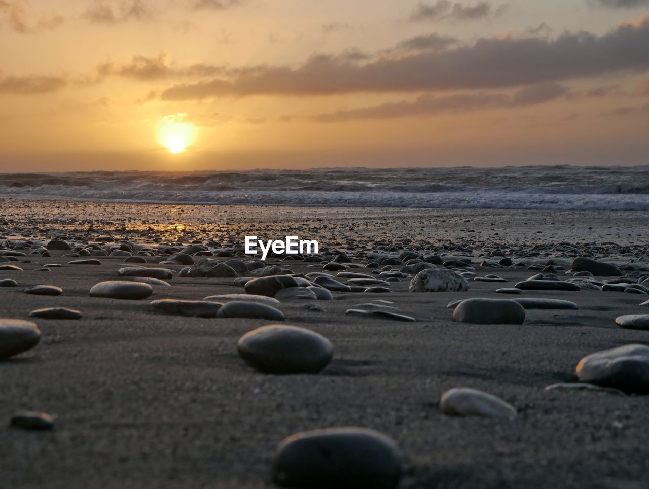 SCENIC VIEW OF BEACH AGAINST SKY DURING SUNSET