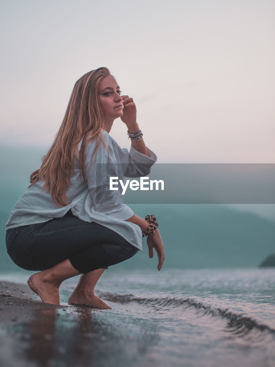 Full length of woman against sky during sunset