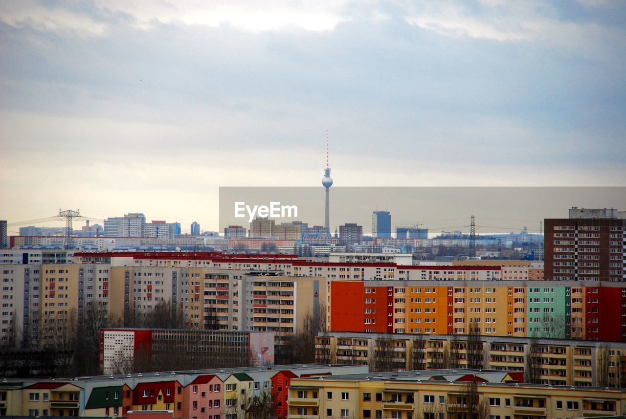 Buildings against cloudy sky