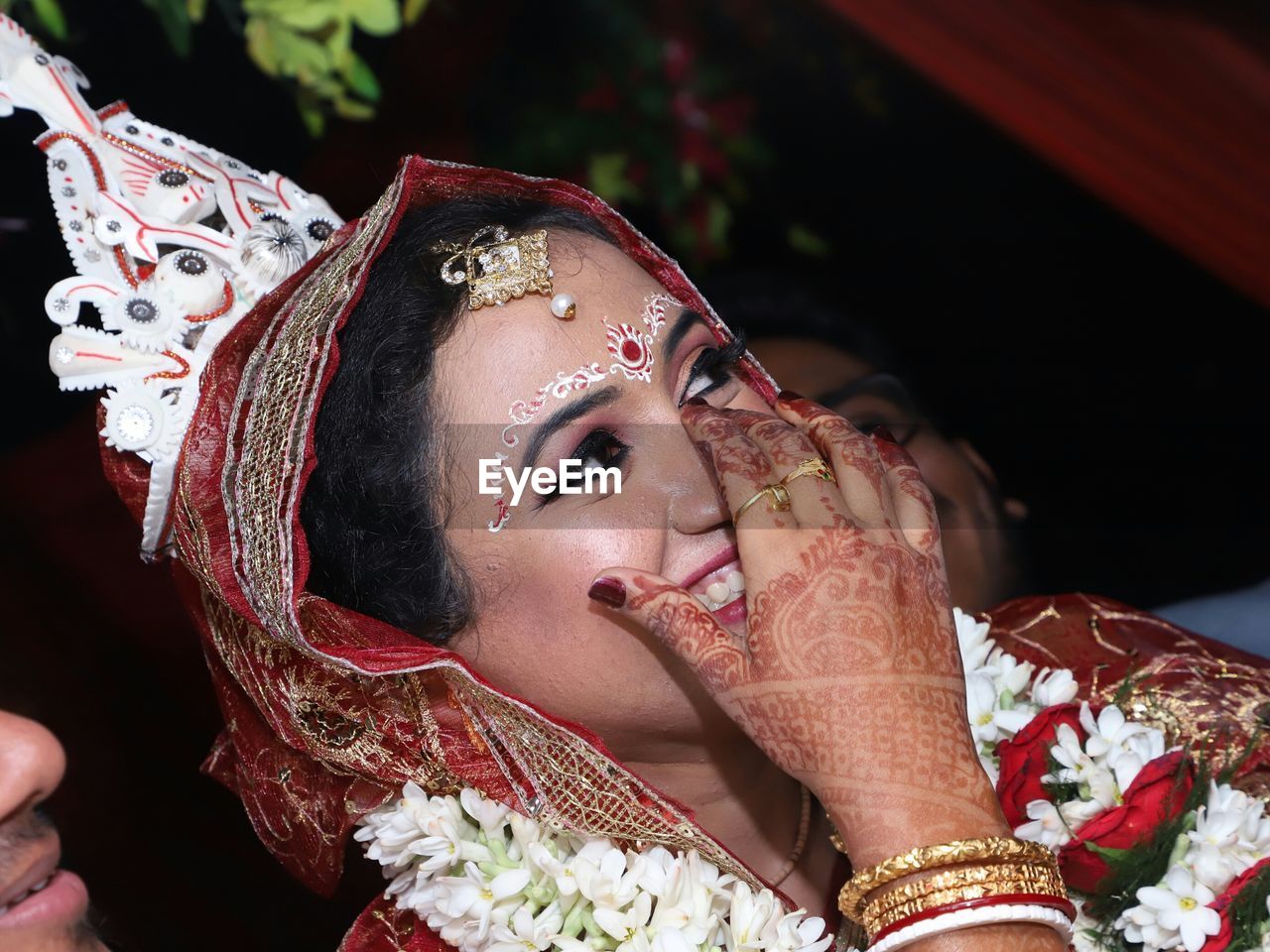 Close-up of smiling bride looking away