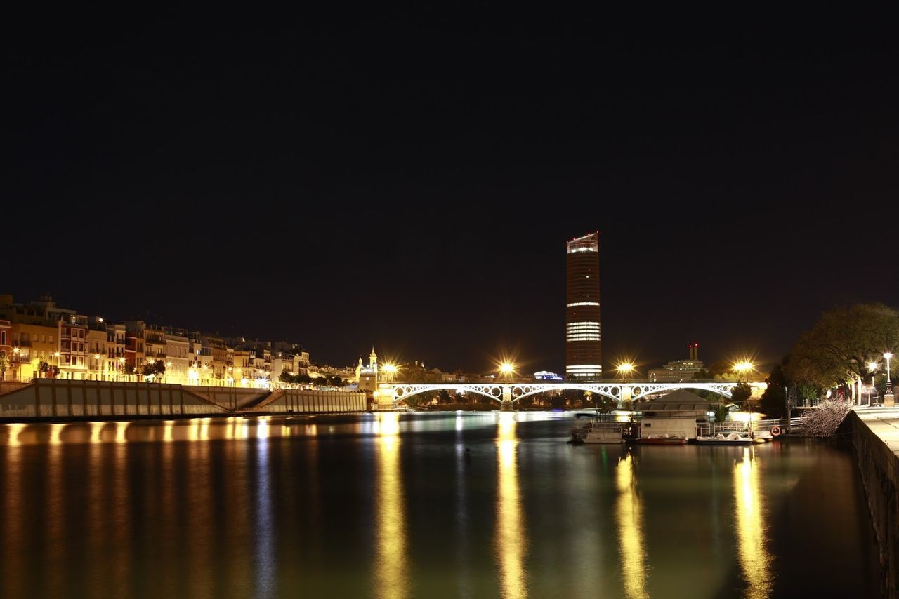 Reflection of illuminated buildings in calm river